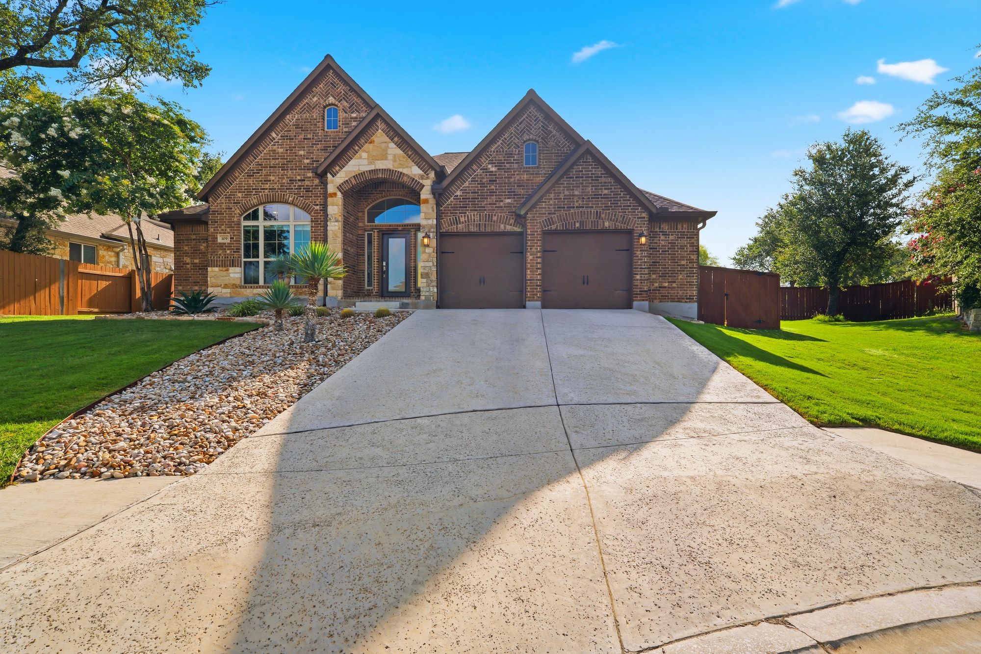 Front of 109 Lake Spring Circle: brick and stone with an arched entry