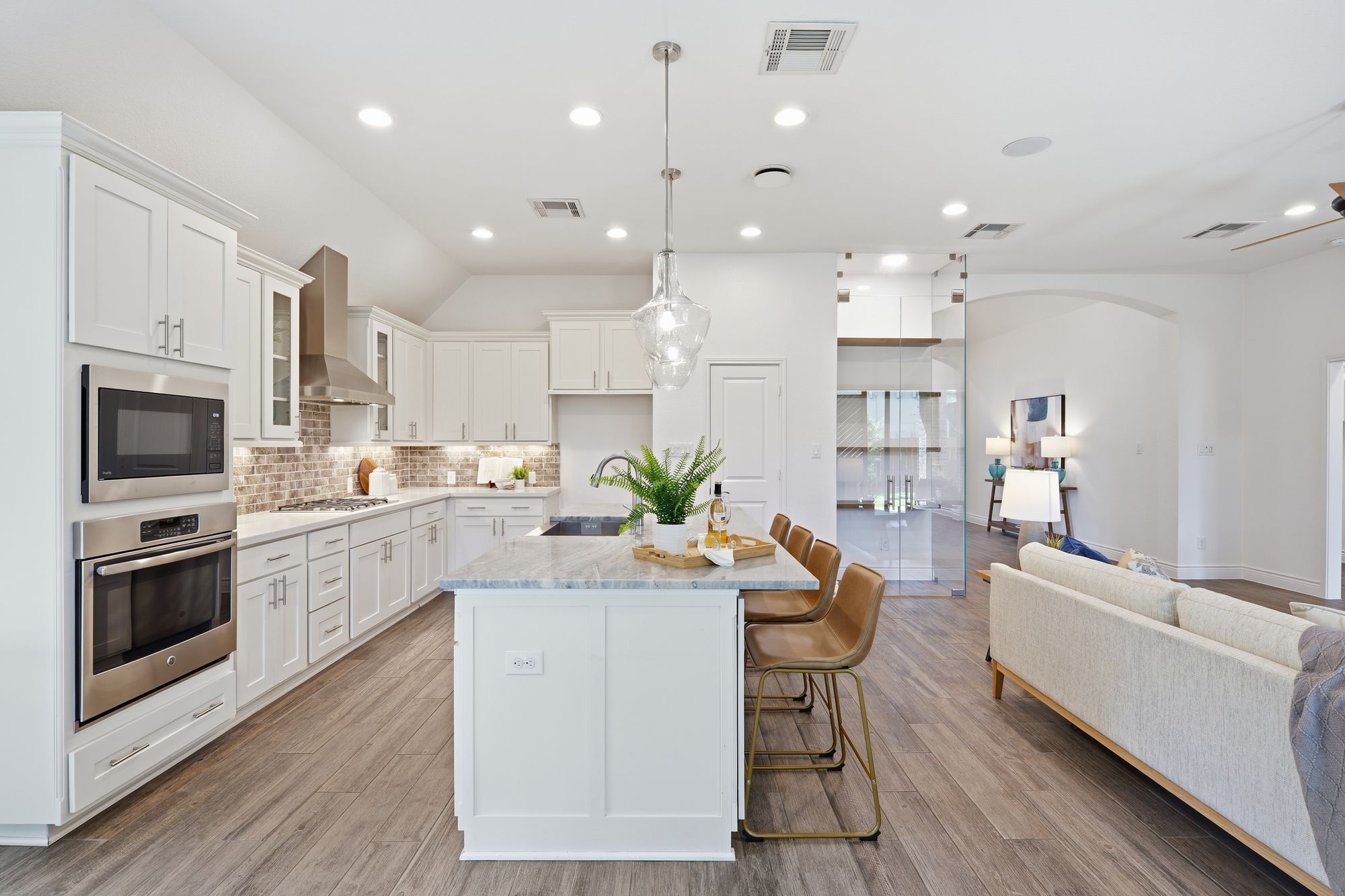 Kitchen with built-in ovens and pendant lighting