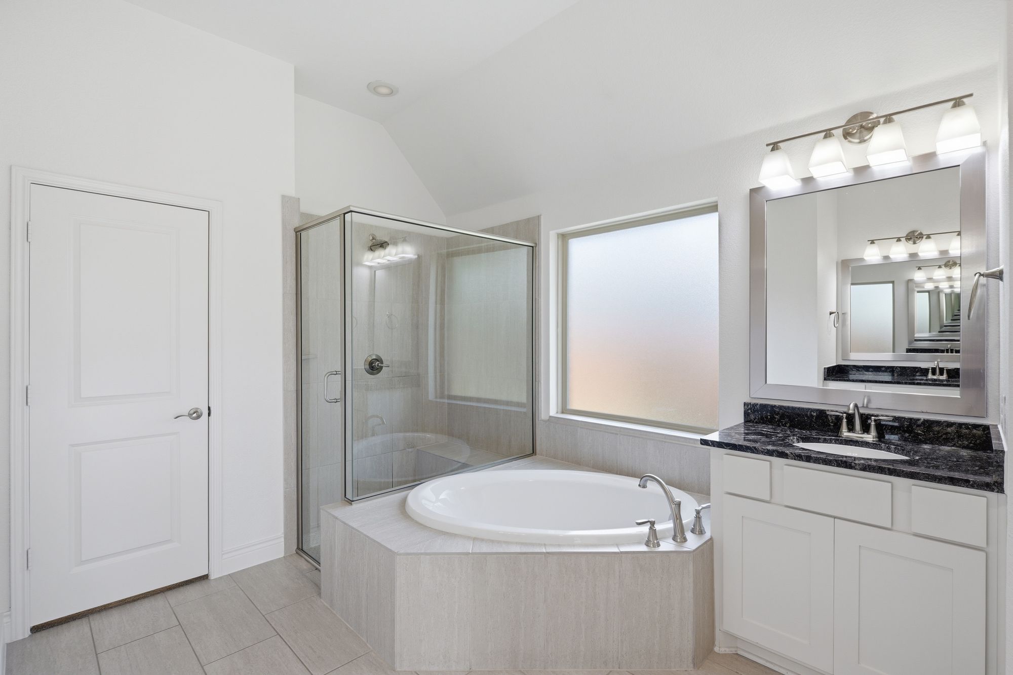 Bath with soaking tub, glass-enclosed shower and vanity