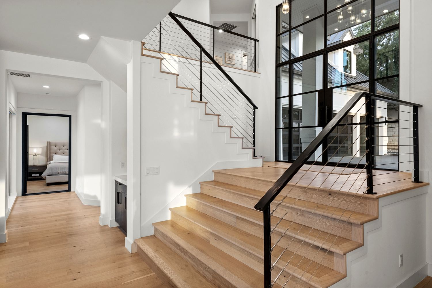 Black-steel cable-railed oak staircase and catwalk