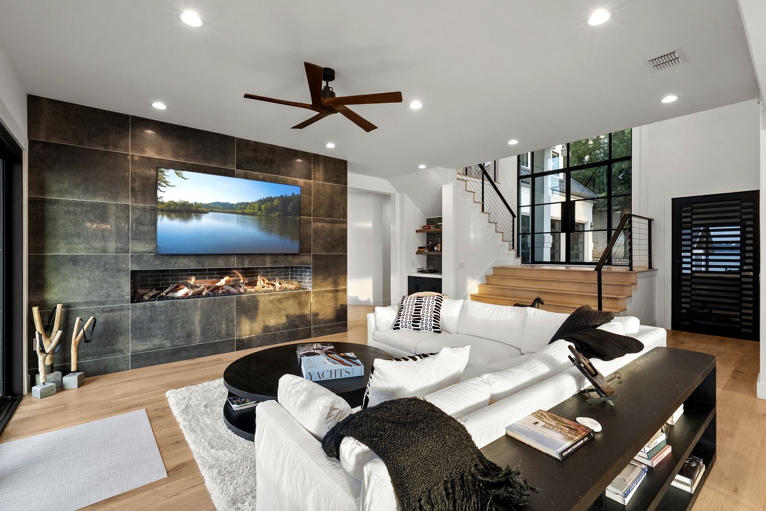 Great room with linear gas fireplace on a metallic-tile feature wall and white-oak floors