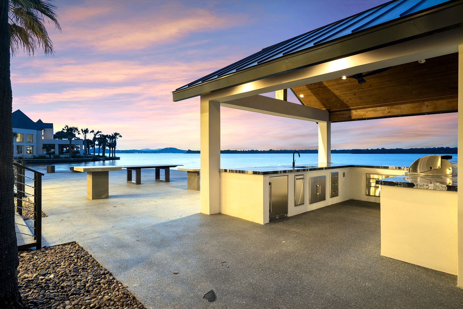 Metal-roofed cabana with full outdoor kitchen at the waterfront